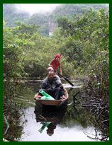 Travel by local canoe to the cave below the Buddha Cave